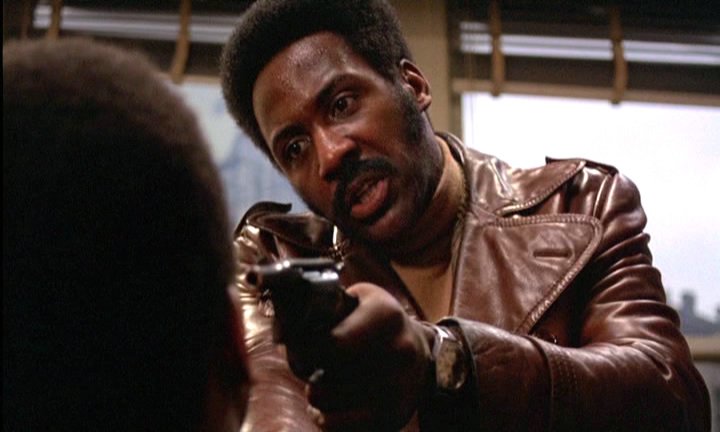 Shaft holds a cat at gunpoint.